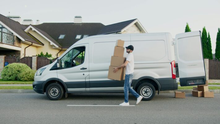 moving - van and a man holding a box